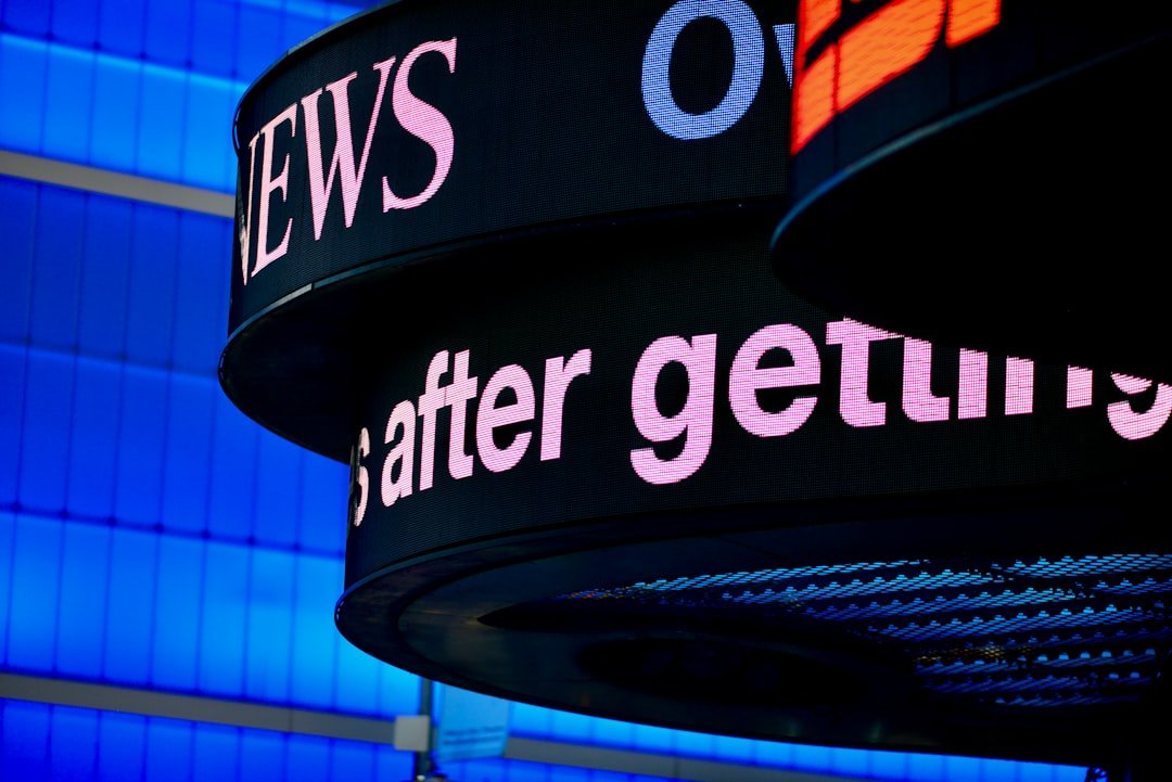 Close-up of signage with building structure in background