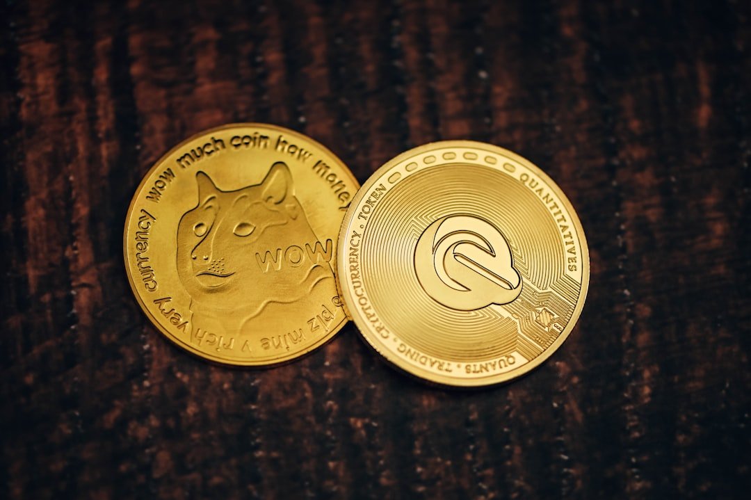 Two gold coins on a wooden table surface